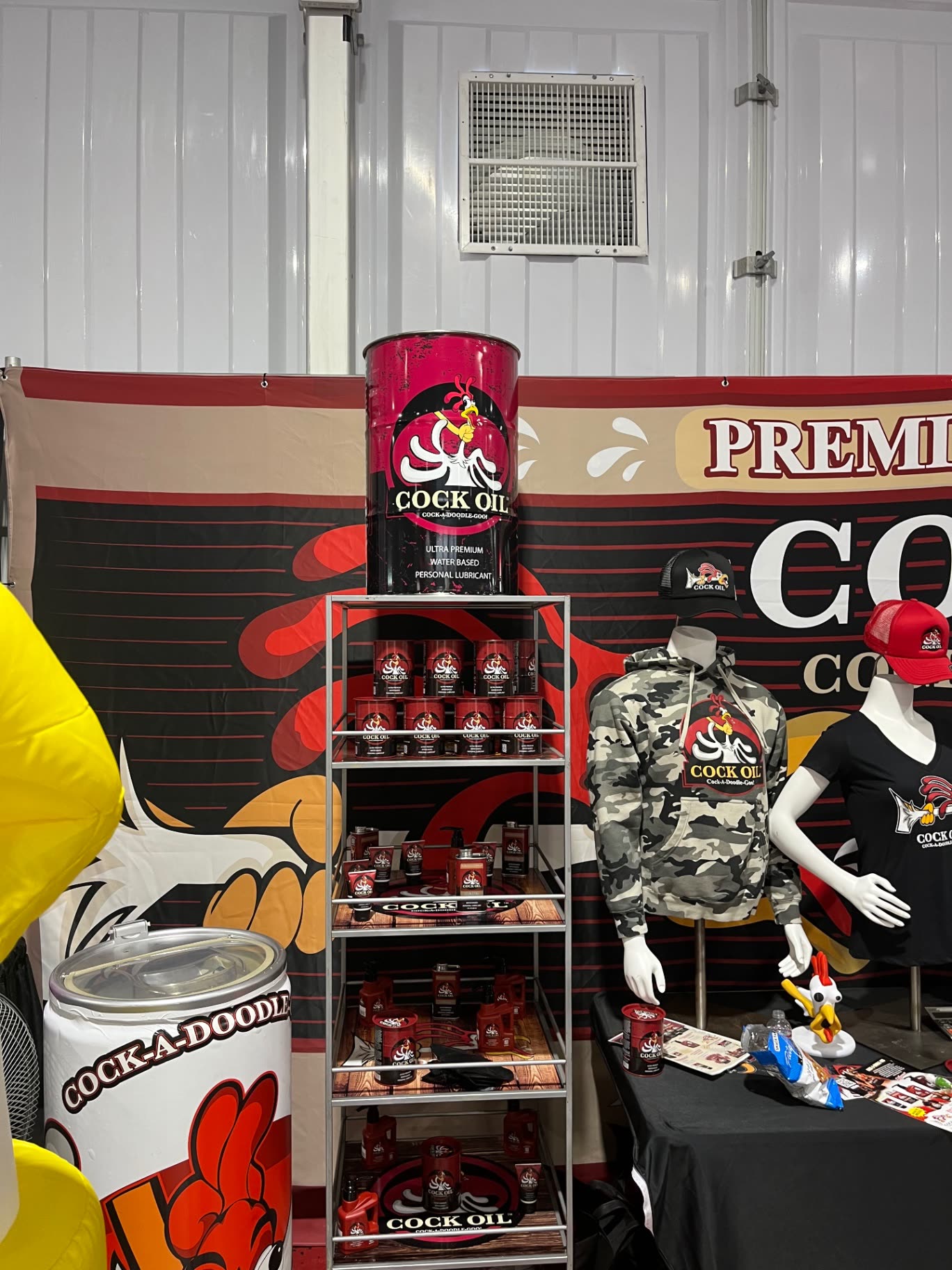 Cock Oil booth merch wall