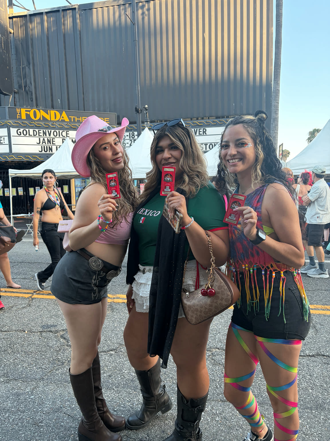 Fans holding Cock Oil samples at LA Pride